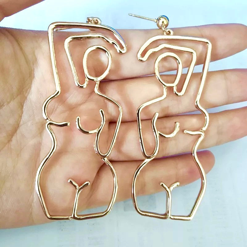 HER STATEMENT EARRINGS