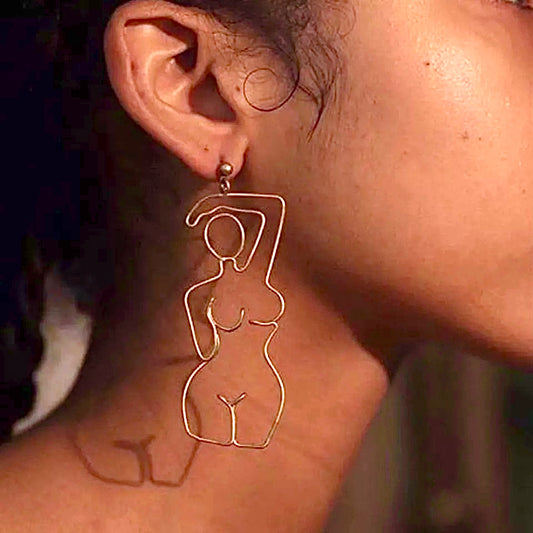 HER STATEMENT EARRINGS